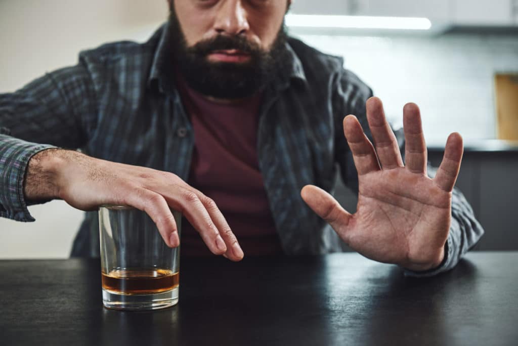 Man choosing to say no to alcohol because he knows what is sobriety