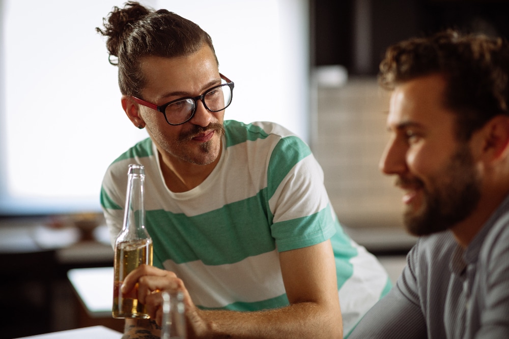 two gay men having drinks - codependency and alcohol addiction