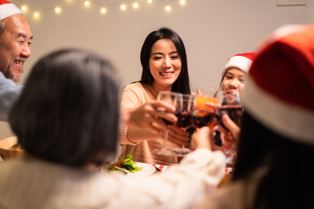 asian family celebrating the holidays - creating a holiday relapse prevention plan