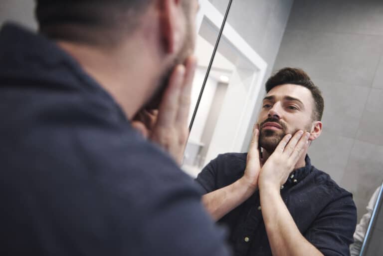 internalized homophobia and substance abuse looking in mirror stressed and upset