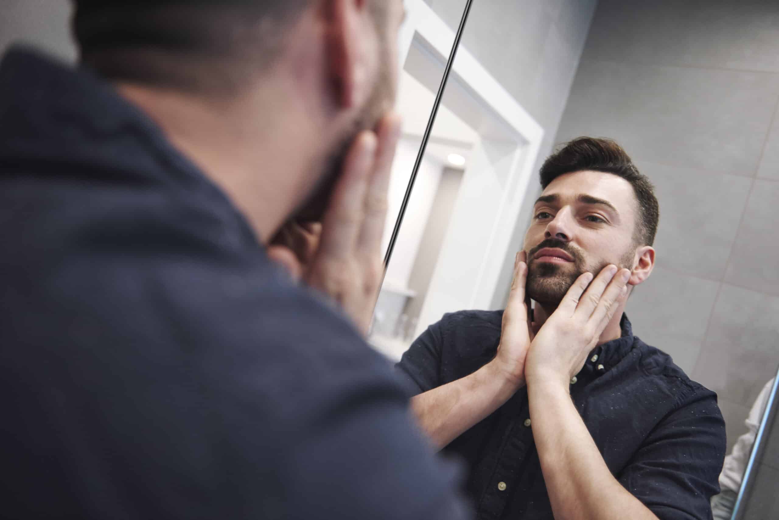 internalized homophobia and substance abuse looking in mirror stressed and upset