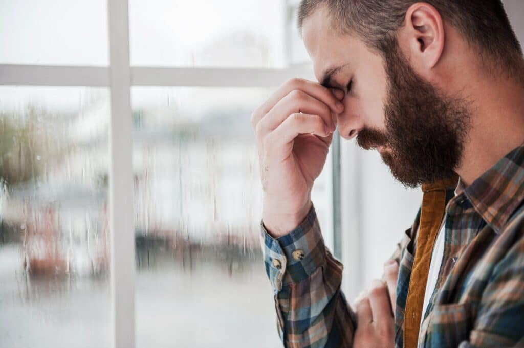 depressed man struggling in addiction recovery - depression and addiction recovery