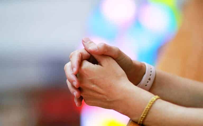 woman praying close up of hands - religious trauma and recovery