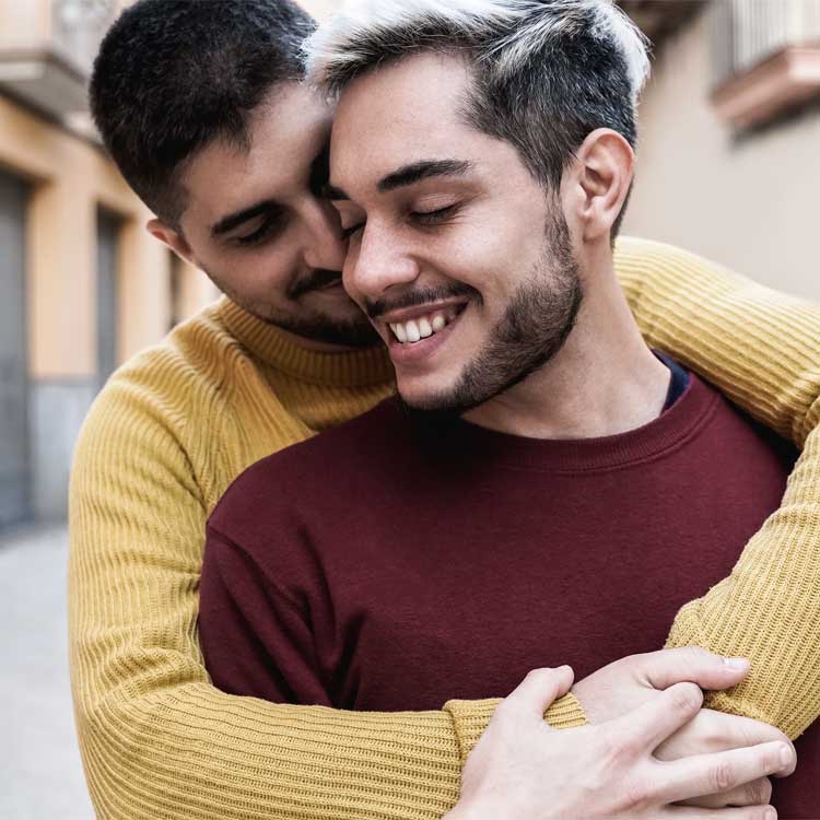 Two gay men embracing in a touching momnet.