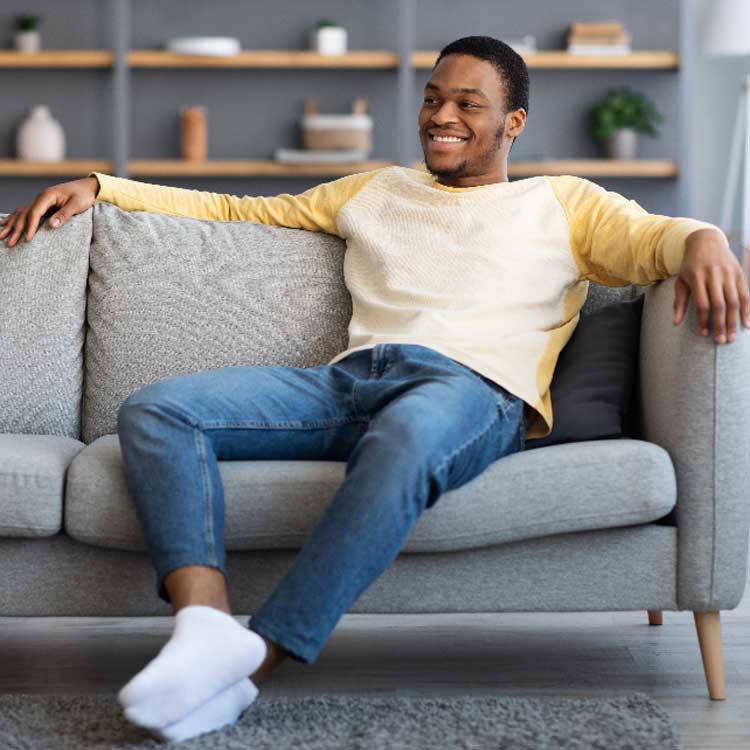 man sitting on couch at residential addiction treatment in los angeles